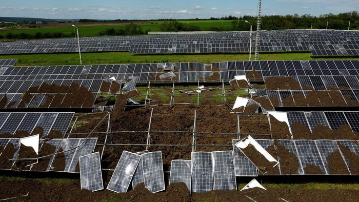 Vladimir Mihailovich, a solar plant manager, walks next to a crater after a shelling hit the station that was producing 2.5 megawatts of power, amid Russia's attack on Ukraine, in the town of Merefa on the outskirts of Kharkiv, Ukraine May 28, 2022. Picture taken with a drone. REUTERS/Ivan Alvarado     TPX IMAGES OF THE DAY