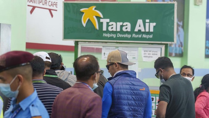 A signage of Tara Airlines is seen behind as a team of climbers prepare to leave for rescue operations from the Tribhuvan International Airport in Kathmandu, Nepal, Sunday, May 29, 2022. A small airplane with 22 people on board flying on a popular tourist route was missing in Nepal’s mountains on Sunday, an official said. The Tara Airlines plane, which was on a 15-minute scheduled flight to the mountain town of Jomsom, took off from the resort town of Pokhara, 200 kilometers (125 miles) east of Kathmandu. It lost contact with the airport tower shortly after takeoff. (AP Photo/Niranjan Shreshta)