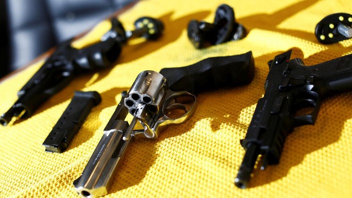 A legal owner poses with his 9mm Sig Sauer P239 after Canadas government introduced legislation to implement a 