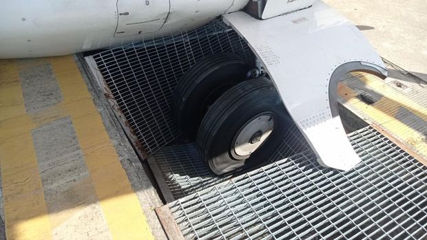 Roda bagian belakang Pesawat Wings Air IW 1963 terperosok masuk ke dalam saluran drainase Bandar Udara Internasional I Gusti Ngurah Rai, Bali, Selasa (31/5/2022) sore.