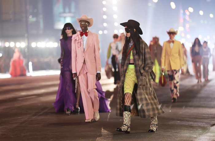 MILAN, ITALY - FEBRUARY 25: Karina Nigay seen wearing beige jacket, brown cowboy hat, white bag, sheer tights, black heels outside Gucci fashion show during the Milan Fashion Week Fall/Winter 2022/2023 on February 25, 2022 in Milan, Italy. (Photo by Christian Vierig/Getty Images)