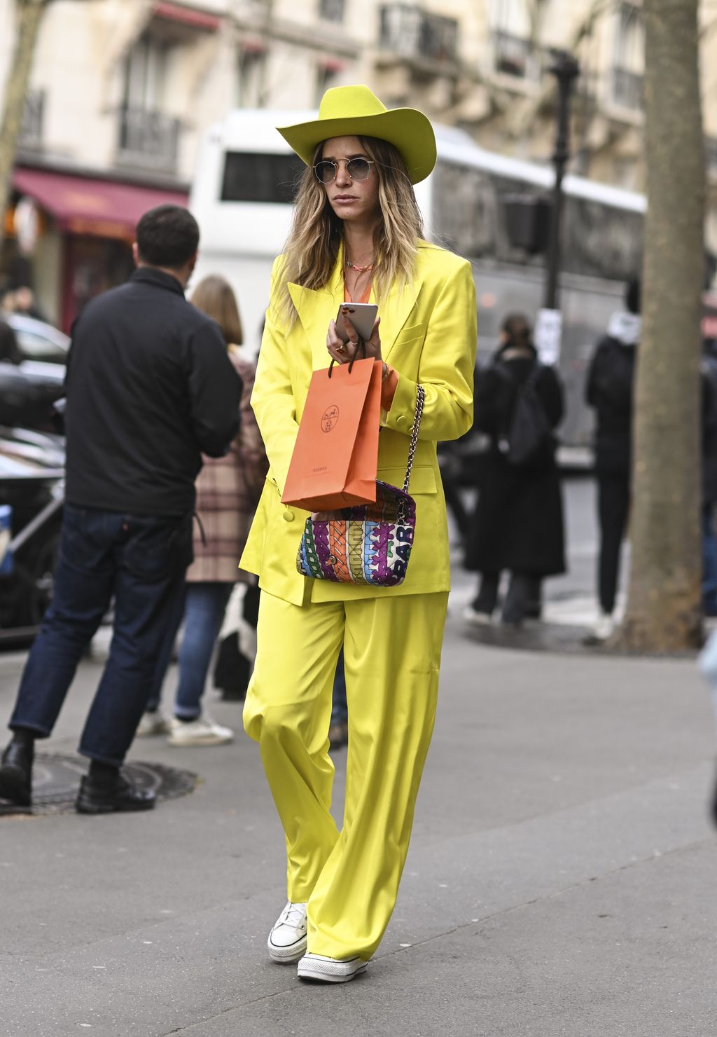 PARIS, FRANCE - MARCH 05: A guest is seen wearing a yellow suit and lime green cowboy hat outside the Hermes show during Paris Fashion Week A/W 2022 on March 05, 2022 in Paris, France. (Photo by Daniel Zuchnik/Getty Images)