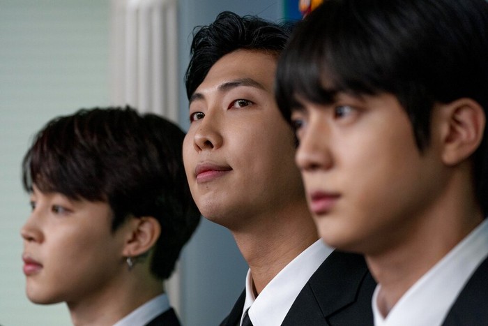 From left, White House press secretary Karine Jean-Pierre joins K-pop supergroup BTS members V, Jungkook, Jimin, RM, Jin, J-Hope, and Suga during the daily briefing at the White House in Washington, Tuesday, May 31, 2022. (AP Photo/Andrew Harnik)