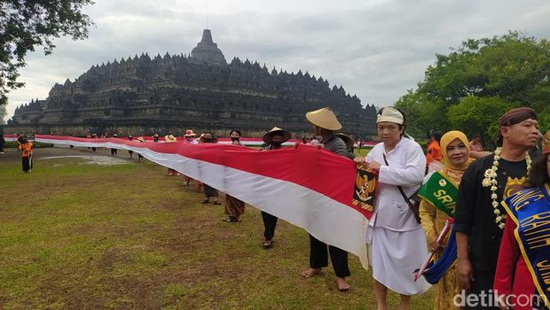 Suasana pembentangan bendera Merah Putih untuk memperingati Hari Lahir Pancasila dengan mengelilingi Candi Borobudur, Kabupaten Magelang, Rabu (1/6/2022).