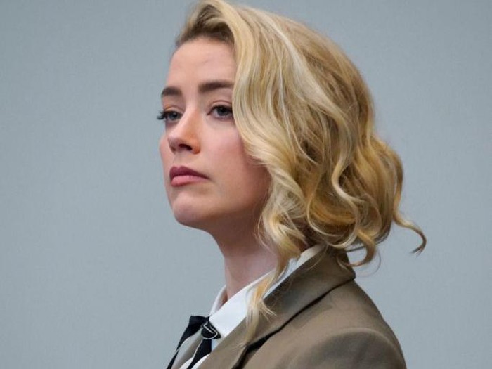 Actor Amber Heard reacts as a pre-recorded deposition testimony of Christian Carino is played during her ex-husband Johnny Depps defamation trial against her, at the Fairfax County Circuit Courthouse in Fairfax, Virginia, April 27, 2022. - US actor Johnny Depp sued his ex-wife Amber Heard for libel in Fairfax County Circuit Court after she wrote an op-ed piece in The Washington Post in 2018 referring to herself as a 