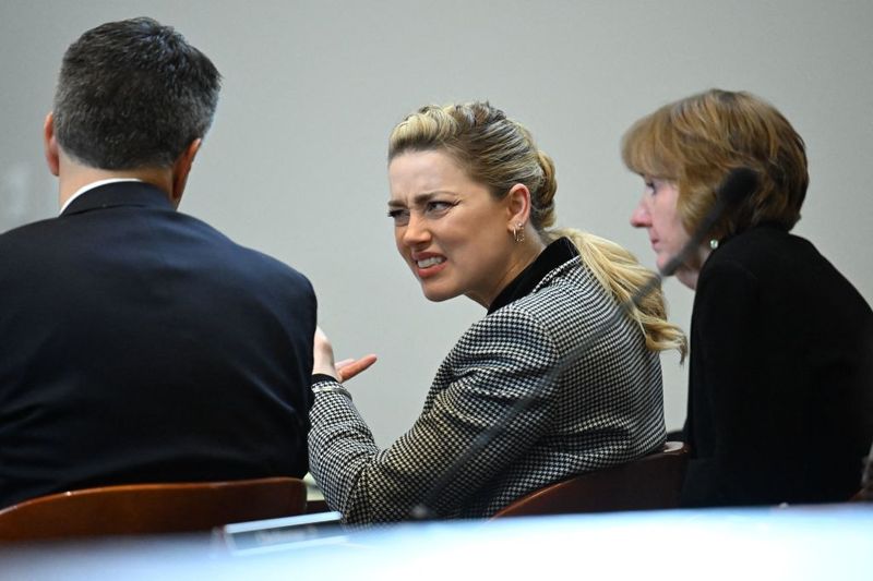 Amber Heard Actor Amber Heard reacts as a pre-recorded deposition testimony of Christian Carino is played during her ex-husband Johnny Depp's defamation trial against her, at the Fairfax County Circuit Courthouse in Fairfax, Virginia, April 27, 2022. - US actor Johnny Depp sued his ex-wife Amber Heard for libel in Fairfax County Circuit Court after she wrote an op-ed piece in The Washington Post in 2018 referring to herself as a