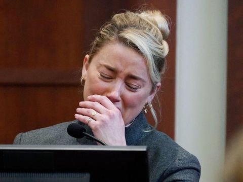 Actor Amber Heard reacts as a pre-recorded deposition testimony of Christian Carino is played during her ex-husband Johnny Depp's defamation trial against her, at the Fairfax County Circuit Courthouse in Fairfax, Virginia, April 27, 2022. - US actor Johnny Depp sued his ex-wife Amber Heard for libel in Fairfax County Circuit Court after she wrote an op-ed piece in The Washington Post in 2018 referring to herself as a 