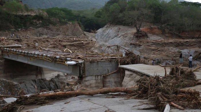 View of the heavily damaged Puente Herradura (Herradura Bridge) after the passage of Hurricane Agatha, in Huatulco, Oaxaca state, Mexico, on June 1, 2022. - At least 22 people remained missing and 11 were confirmed dead Wednesday after Hurricane Agatha swept through Mexico, local officials said.The storm made landfall along Mexico's Pacific coast Monday, the strongest since record keeping began in 1949, according to the US National Hurricane Center (NHC). (Photo by Gil OBED / AFP) (Photo by GIL OBED/AFP via Getty Images)