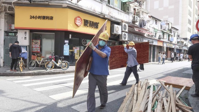 Shanghai mulai kembali hidup normal usai lockdown di wilayah itu dilonggarkan. Pagar pembatas yang sebelumnya di pasang di sisi-sisi jalan kini mulai dibongkar.