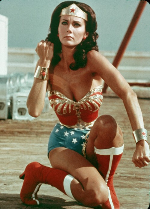 American actor Lynda Carter kneels on the ground and bears her forearm in a still from the television series Wonder Woman. (Photo by Warner Brothers/Getty Images)