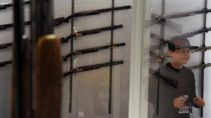 A child walks through a rifle exhibit as attendees try out the guns on display at the National Rifle Association (NRA) annual convention in Houston, Texas, U.S. May 28, 2022. REUTERS/Callaghan O'Hare
