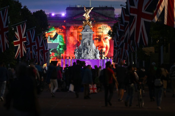 LONDON, ENGLAND - JUNE 02: Projections displayed on the front of Buckingham Palace depicting Queen Elizabeth II during The Lighting Of The Principal Beacon at Buckingham Palace on June 02, 2022 in London, England. The Platinum Jubilee of Elizabeth II is being celebrated from June 2 to June 5, 2022, in the UK and Commonwealth to mark the 70th anniversary of the accession of Queen Elizabeth II on 6 February 1952.  (Photo by Chris Jackson -WPA Pool/Getty Images)