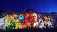 Video mapping itu menggambarkan Ratu Elizabeth II dari masa ke masa melalui acara bertajuk The Lighting Of The Principal Beacon.  Foto: Getty Images/Chris Jackson