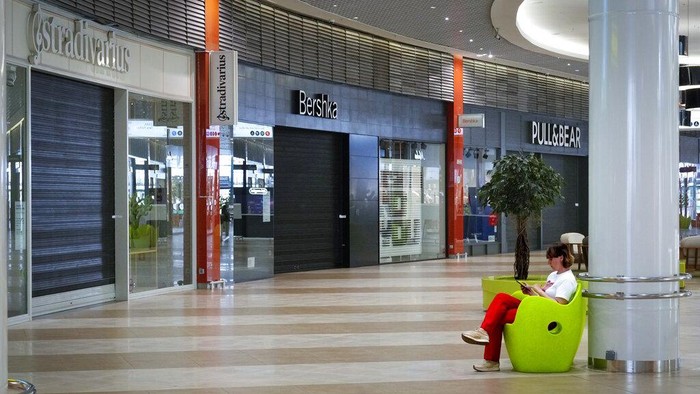 Mal di Rusia Nyaris Kosong Melompong Ditinggal Perusahaan Barat A woman walks at an almost empty shopping center with many shops closed due to sanctions, in St. Petersburg, Russia, Wednesday, June 1, 2022. Many Western retailers have left Russia after the start of a military action in Ukraine. (AP Photo/Dmitri Lovetsky)