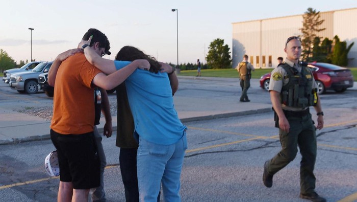 Survivors hugs their family members and friends at the Cornerstone Baptist church parking lot after a  shooting outside the church in Ames, Iowa, U.S. June 2, 2022. Picture taken June 2, 2022.  Nirmalendu Majumdar/USA Today Network via REUTERS.   NO RESALES. NO ARCHIVES. MANDATORY CREDIT