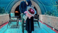 Makan bersama romantis kerap dilakukan oleh pasangan muda ini. Mereka menikmati makan romantis di restoran bawah akuarium raksasa. Foto: Instagram @riarics1795