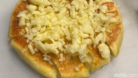 Ciri khas jajanan yang satu ini terletak pada penggunaan kentang tumbuk dan taburan keju mozzarella di dalam adonan roti. Ketika dipanggang semua lapisan roti, keju dan kentang menyatu hingga enak rasanya. Foto: detikFood