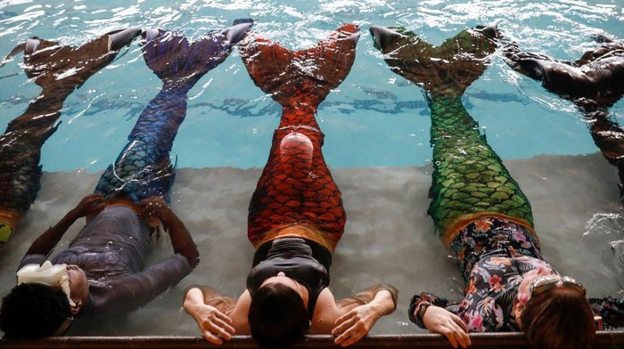 Students perform a routine during their mermaiding class at the Merschool in Kayalami, near Midrand, on June 3, 2022. - Mermaiding is a fast growing sport world wide and includes several skills such as monofin swimming, sculling, tricks and breath hold. (Photo by Phill Magakoe / AFP) (Photo by PHILL MAGAKOE/AFP via Getty Images)