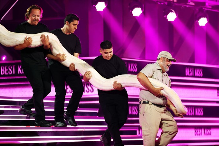SANTA MONICA, CALIFORNIA - JUNE 05: A snake is brought onstage while Sean ‘Poopies’ McInerney accepts the Best Kiss award for ‘Jackass Forever’ during the 2022 MTV Movie & TV Awards at Barker Hangar on June 05, 2022 in Santa Monica, California. (Photo by Rich Polk/Getty Images for MTV)