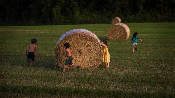 A group of children play in the countryside near Vilademuls, Girona, Spain, Sunday, June 5, 2022. (AP Photo/Emilio Morenatti)