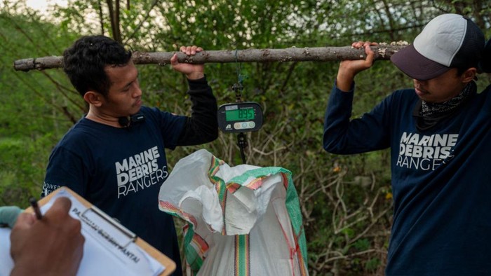 Environmental activists weighed samples of plastic waste taken from Palu Bay Beach, Central Sulawesi Province, Indonesia on June 5, 2022.  The sampling is to ensure the level of pollution of plastic waste, especially plastic packaging in the region, to be reported to the government in order to take countermeasures. Indonesia is the second largest producer of marine plastic waste in the world after China with a waste volume of 3.8 million tons per year. This figure is increasing in line with population growth and urbanization that occurs. The Government of Indonesia has developed an Action Plan to Reduce Plastic Waste in the Ocean and targets to reduce the volume of plastic waste in the ocean by 30 percent for plastic packaging waste by 2028 and 70 percent for plastic waste in the ocean as a whole by 2024. (Photo by Basri Marzuki/NurPhoto via Getty Images)