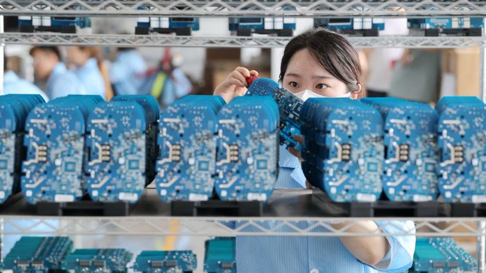 DEQING, CHINA - JUNE 06: An employee works on the assembly line of electric charging units for new energy vehicles at a factory on June 6, 2022 in Deqing County, Huzhou City, Zhejiang Province of China. (Photo by Xie Shangguo/VCG via Getty Images)