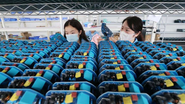 DEQING, CHINA - JUNE 06: An employee works on the assembly line of electric charging units for new energy vehicles at a factory on June 6, 2022 in Deqing County, Huzhou City, Zhejiang Province of China. (Photo by Xie Shangguo/VCG via Getty Images)