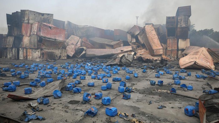 Containers of chemicals lie scattered after explosion at the BM Inland Container Depot, where a fire broke out around midnight Saturday in Chittagong, about 210 kilometers (130 miles) southeast of, Dhaka, Bangladesh, Monday, June 6, 2022. Dozens of people were killed and more than 100 others were injured after the inferno broke out following explosions in a container full of chemicals. (AP Photo)