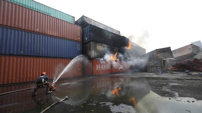 Containers of chemicals lie scattered after explosion at the BM Inland Container Depot, where a fire broke out around midnight Saturday in Chittagong, about 210 kilometers (130 miles) southeast of, Dhaka, Bangladesh, Monday, June 6, 2022. Dozens of people were killed and more than 100 others were injured after the inferno broke out following explosions in a container full of chemicals. (AP Photo)