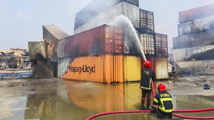 Containers of chemicals lie scattered after explosion at the BM Inland Container Depot, where a fire broke out around midnight Saturday in Chittagong, about 210 kilometers (130 miles) southeast of, Dhaka, Bangladesh, Monday, June 6, 2022. Dozens of people were killed and more than 100 others were injured after the inferno broke out following explosions in a container full of chemicals. (AP Photo)