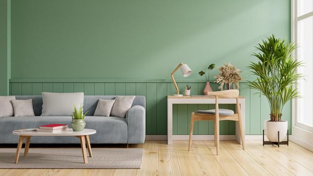Interior mockup green wall with blue sofa and work table set in living room.3D rendering