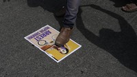 Seorang demonstran menginjak poster bergambar juru bicara Partai Bharatiya Janata (BJP) Nupur Sharma yang menjadi sasaran kemarahan publik karena melontarkan komentar yang menghina Nabi Muhammad SAW, di Mumbai, India, Senin (6/6/2022). (AP Photo/Rafiq Maqbool).