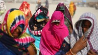 Para warga terlihat menggunakan penutup kepala untuk berlindung dari panasnya cuaca.