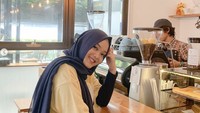 Mampir ke coffee shop Instagramable rasanya tak lengkap kalau tak foto. Putri juga pose dengan latar mesin kopi nih!