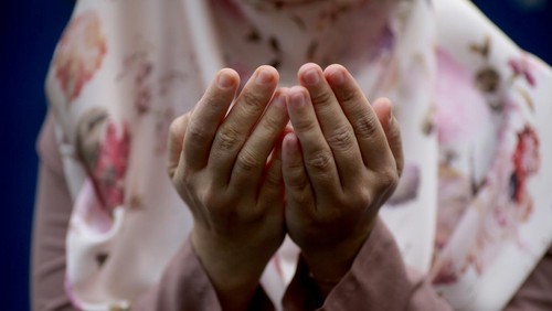 Asian muslim girl worried of her father being sick in hospital, she holds her fathers hand and pray for his health, family health insurance concept