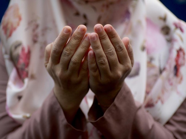 Asian muslim girl worried of her father being sick in hospital, she holds her fathers hand and pray for his health, family health insurance concept