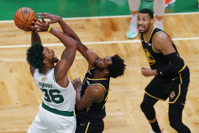 Boston Celtics guard Marcus Smart (36) puts up a shot against Golden State Warriors forward Andrew Wiggins (22) during the fourth quarter of Game 3 of basketballs NBA Finals, Wednesday, June 8, 2022, in Boston. (AP Photo/Michael Dwyer)