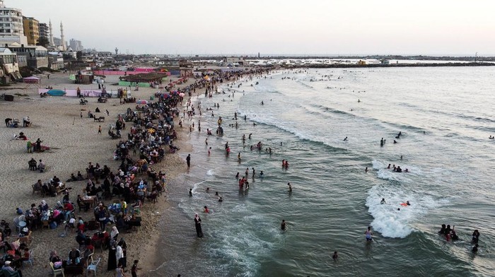 Palestinians enjoy the beach in Gaza City June 8, 2022. Picture taken June 8, 2022. Picture taken with drone.      REUTERS/Mohammed Salem