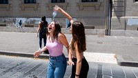 Seorang remaja menyiram temannya dengan air dari botol saat merayakan hari terakhir sekolah di Rieti, Italia, Rabu (8/6/2022). Rieti berada di tengah-tengah Italia, sekitar 65 km sebelah timur laut Ibu Kota Roma.