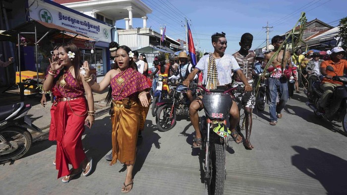 Local villagers march in a ceremony to invoke rain amid the rice planting season in Pring Ka-ek village, northwest of Phnom Penh, Cambodia, Thursday, June 9, 2022. Local residents Thursday held the annual Buddhist ceremony to pray for the rain to grow rice as their main crop. (AP Photo/Heng Sinith)