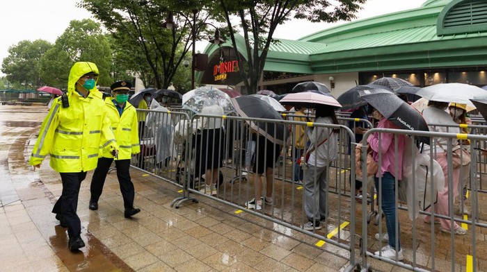 SHANGHAI, CHINA - JUNE 10: Visitors walk the grounds at Shanghai Disney Resort on June 10, 2022 in Shanghai, China. Shanghai Disney Resort is resuming partial operations, with reduced capacity and opening hours, as COVID-19 cases ease in the city. (Photo by Hu Chengwei/Getty Images)
