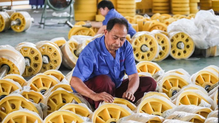 HUAI'AN, CHINA - JUNE 09: An employee manufactures elevator rollers at the workshop of a company on June 9, 2022 in Huai'an, Jiansu Province of China. (Photo by Zhao Qirui/VCG via Getty Images)