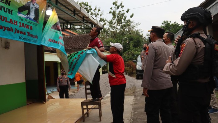 Pencopotan spanduk di kantor Khilafatul Muslimin di Sukoharjo, Kamis (9/6/2022).
