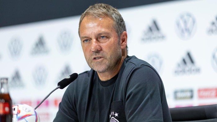 10 June 2022, Bavaria, Herzogenaurach: Soccer: National team, before the Nations League match in Hungary. Coach Hansi Flick takes part in a press conference. Photo: Daniel Karmann/dpa - IMPORTANT NOTE: In accordance with the requirements of the DFL Deutsche Fußball Liga and the DFB Deutscher Fußball-Bund, it is prohibited to use or have used photographs taken in the stadium and/or of the match in the form of sequence pictures and/or video-like photo series. (Photo by Daniel Karmann/picture alliance via Getty Images)