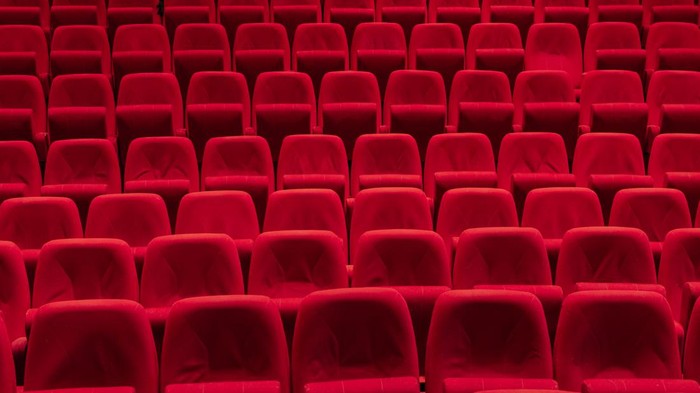 ilustrasi bioskop Cinema theater with Red Seats. Red and empty theater seats in a row