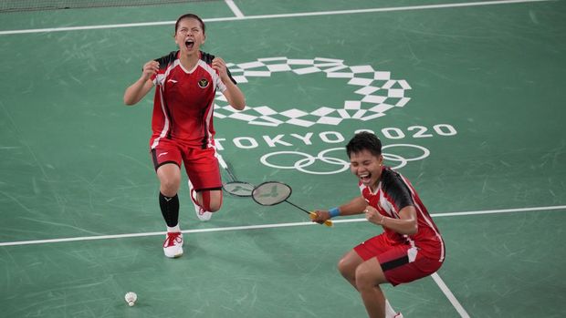 Indonesia's Greysia Polii, left, and Apriyani Rahayu celebrate after defeating South Korea's Lee So-hee and Shin Seung-chan during their women's singles badminton semifinal match at the 2020 Summer Olympics, Saturday, July 31, 2021, in Tokyo, Japan. (AP Photo/Dita Alangkara)