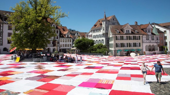 A giant picnic blanket covers streets and Klosterhof square during the BIGNIK art installation initiated by Swiss concept artists Frank and Patrik Riklin in the old town of St. Gallen, Switzerland June 12, 2022. Picture taken with a drone. REUTERS/Arnd Wiegmann     TPX IMAGES OF THE DAY