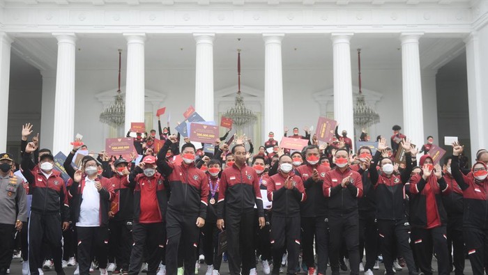 Presiden Joko Widodo (kanan) berjabat tangan dengan karateka peraih medali perak Ceyco Georgia Hutagalung (ketiga kiri) saat upacara penyerahan bonus atlet SEA Games ke-31 Vietnam di Halaman Istana Merdeka, Jakarta, Senin (13/6/2022). Presiden menyerahkan total bonus kepada seluruh atlet sebesar Rp130,5 Miliar sementara untuk pelatih dan asisten pelatih sebesar Rp32 Miliar. ANTARA FOTO/Akbar Nugroho Gumay/nz