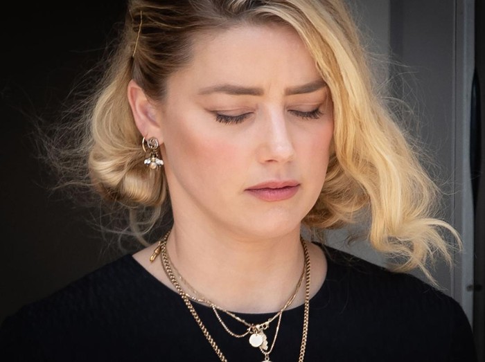 FAIRFAX, VA - JUNE 1: (NY & NJ NEWSPAPERS OUT) Amber Heard departs the Fairfax County Courthouse after the verdict announced_on June 1, 2022 in Fairfax, Virginia. The jury in the Johnny Depp vs. Amber Heard case awarded Depp $15 million in damages to his career over an op-ed Heard wrote in the Washington Post in 2018.(Photo by Cliff Owen/Consolidated News Pictures/Getty Images)