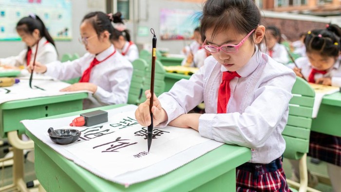 HOHHOT, CHINA - JUNE 13: A student shows his handwriting work during a calligraphy competition at a primary school on June 13, 2022 in Hohhot, Inner Mongolia Autonomous Region of China. (Photo by Ding Genhou/VCG via Getty Images
